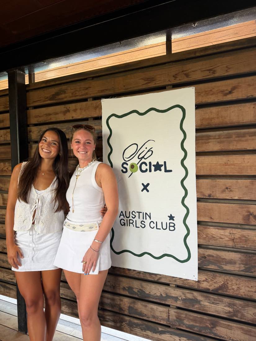 Hand-painted Sip Social x Austin Girls Club banner at a partnered event